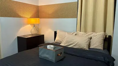 a bedroom with a bed with a box on it at Super Cozy Apartment-Newport Boulevard in Manila