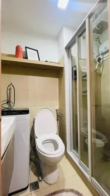 a bathroom with a toilet and a sink and a shower at Lana Haven in Manila