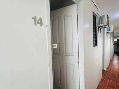 a hallway with a door with the number on it at T&A Building in Manila