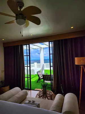 a living room with a couch and a view of the ocean at OYO 1175 Casa Ana in Manila