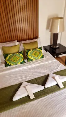 a bedroom with two beds with towels on them at OYO 1175 Casa Ana in Manila