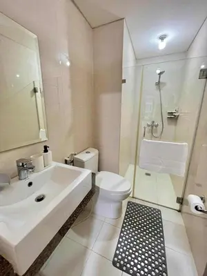 a white bathroom with a sink and a toilet at Big Studio Condo Across Manila Airport NAIA T3 WITH WIFI in Manila