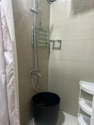 a shower with a black toilet in a bathroom at Shore 2 Residences - The Grand Haven in Manila