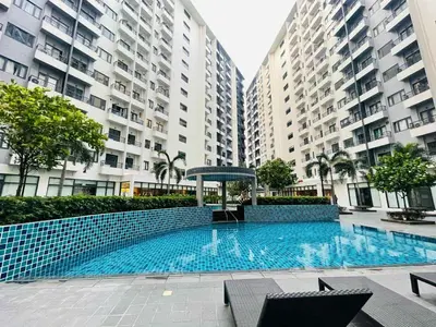 a swimming pool in the middle of two tall buildings at Cozy Staycation Suite at Rossy's Place near in Paranaque in Manila