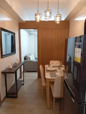 a dining room and living room with a table and chairs at Cozy Staycation Suite at Rossy's Place near in Paranaque in Manila
