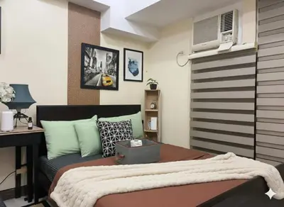 a bedroom with a bed and a desk and a computer at NAIA Manila Airport - Newport Prime Accommodations in Manila