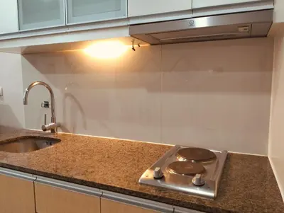 a kitchen counter with a stove and a sink at NAIA Manila Airport - Newport Prime Accommodations in Manila