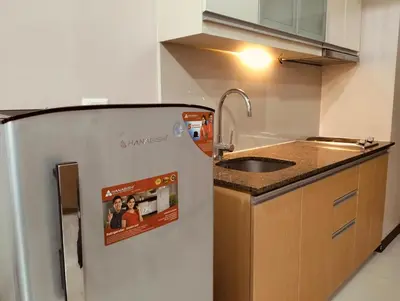 a kitchen with a sink and a refrigerator at NAIA Manila Airport - Newport Prime Accommodations in Manila