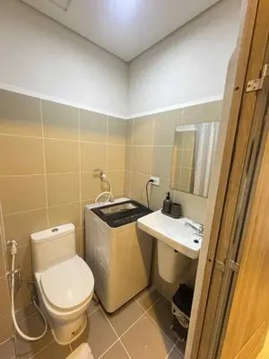 a small bathroom with a toilet and a sink at Canadian Suite at Coast Residences Penthouse in Manila