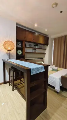 a room with a desk and a bed in a room at Christine Suites PH at The Gramercy Residences Makati in Manila