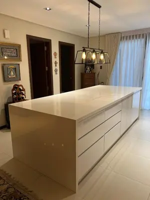 a kitchen with a white island in a room at Super cozy Family Villa in Manila