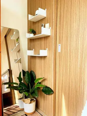 a room with a wall with shelves and a plant at Casa Felice at Shore 2 Residences in Manila