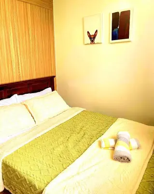a bedroom with a bed with two towels on it at Casa Felice at Shore 2 Residences in Manila