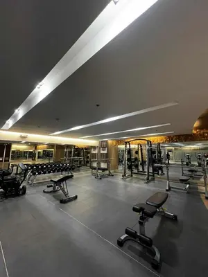 a gym with a lot of exercise equipment in a building at Shore Residences MOA in Manila