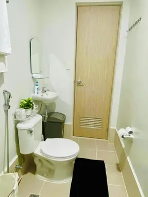 a bathroom with a toilet and a sink at Condo Stay Near SM City Santa Rosa Mall in Ibaba