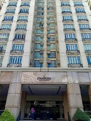 a large building with a sign in front of it at Cozy Cabin by JLS Near Venice Grand Canal Mall in Manila