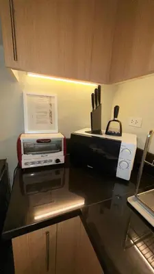 a kitchen with a counter top with appliances on it at Best Value-Beautiful 1BR in the Heart of Makati w WiFi, washer-dryer, pool & gym in Manila