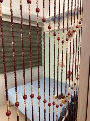 a bunch of wooden beads hanging from a wall at Greece Theme Boni MRT Train Edsa 1BR with Netflix Fast Internet Pool Light Mall in Manila