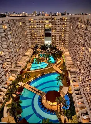 an aerial view of a large building with a pool at Staycation Near Mall of Asia in Manila