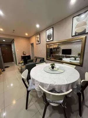 a living room with a table with chairs and a mirror at Staycation Near Mall of Asia in Manila