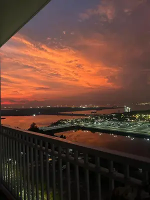 a view from a balcony of a city at night at E&T staycation in Manila