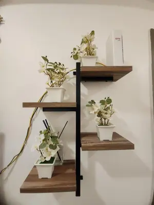 a shelf with three potted plants on it at Japan Vibe Shaw MRT Train EDSA 1BR with Veranda Netflix Internet Pool View in Manila