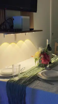 a table with plates and flowers on a blue table cloth at 2- Bedroom Condo in Metro Manila - Azure Beach in Manila