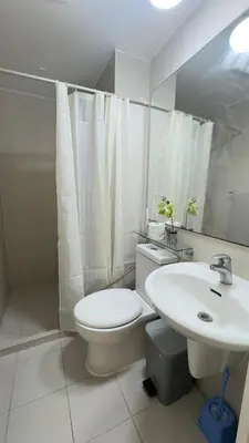 a white bathroom with a toilet and a sink at 2- Bedroom Condo in Metro Manila - Azure Beach in Manila