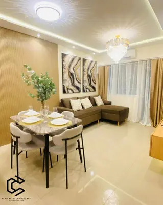 a living room with a table and a couch at Serenity Suite Smart Condo 2 BR Balcony in Manila
