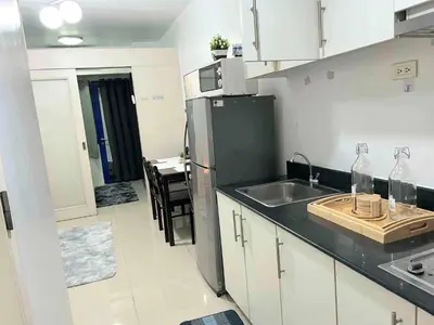 a small kitchen with a sink and a refrigerator at Sea Affordable staycation in Manila