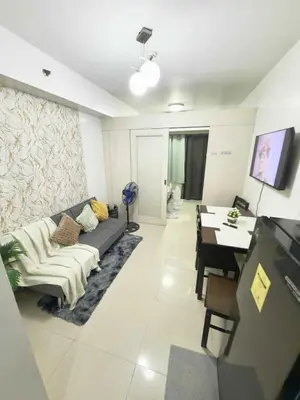 a living room with a couch and a table at Sea Affordable staycation in Manila