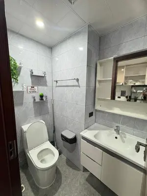 a bathroom with a toilet and a sink at Sybay Suites twin double bed beside Okada near T3 MOA NAIA Ayala MSV1517H in Manila