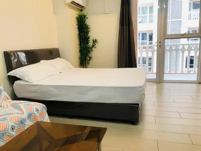 a bedroom with a bed and a table and a window at Charming 1BR with Balcony near Venice mall&BGC in Manila