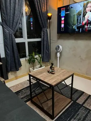 a coffee table in a living room with a tv at Thailand Theme 1BR Free Pool Gym Internet Netflix Sunshine 100 T3 Pioneer Mandaluyong in Manila