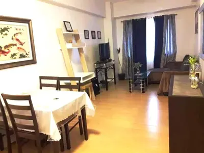 a living room with a table and a couch at Althea's Homestay at Forebeswood Height in Manila