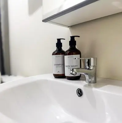 two bottles sitting on top of a bathroom sink at Kasara Urban Resort Residences by Amari Staycations in Manila