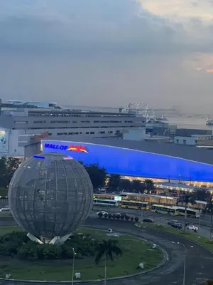 a view of a city with a large building at Shell Residences Mall of Asia Caitlin's Place in Manila