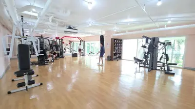 a gym with a person standing in the middle of the room at Cosy Makati Penthouse Studio with Great View in Manila
