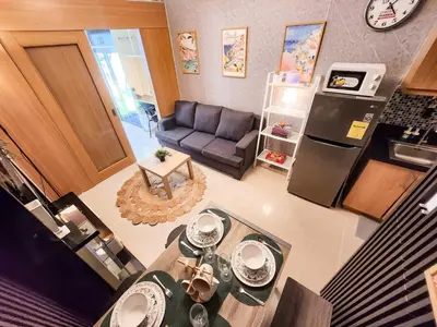 an overhead view of a kitchen and a living room at Amazing Poolside 1br MOA Netflix 100mbps fiber in Manila