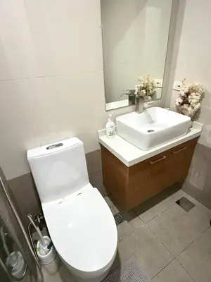 a bathroom with a white toilet and a sink at European Vibe 1BR Great River City View Free Pool Gym Internet Netflix in Manila