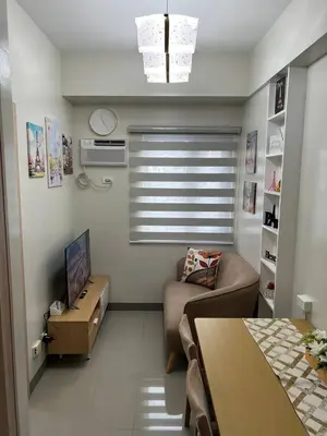 a small living room with a couch and a television at Paris Theme Near Ayala Feliz Mall 2BR Netflix Internet with Pool Parking Fee in Manila