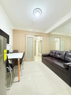 a living room with a couch and a table at Dreamstaycation shore residences in Manila