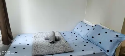 a bed with polka dot pillows in a bedroom at Sea Residences in Manila