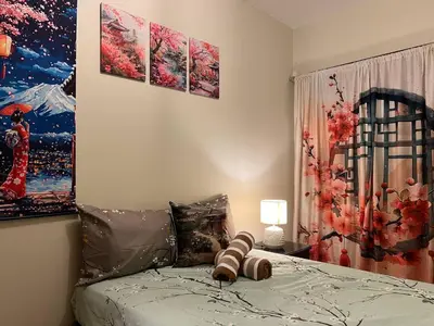 a bedroom with a bed with three paintings on the wall at Japan Vibe near Ayala Feliz Mall 2BR 55sqm with Veranda Netflix Pool in Manila