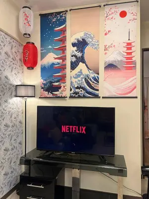 a living room with a tv and a wall with paintings at Japan Vibe near Ayala Feliz Mall 2BR 55sqm with Veranda Netflix Pool in Manila