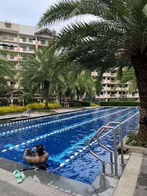 a man taking a picture of a swimming pool at Japan Vibe near Ayala Feliz Mall 2BR 55sqm with Veranda Netflix Pool in Manila