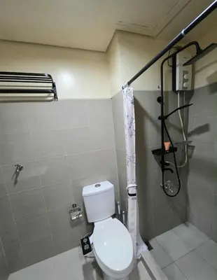 a bathroom with a toilet and a shower at Kaizen Pod - Shore Residences Staycation, MOA Complex, Near airport in Manila