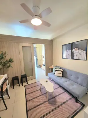 a living room with a couch and a table at Kaizen Pod - Shore Residences Staycation, MOA Complex, Near airport in Manila