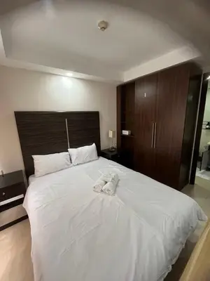 a large white bed with a towel on it at A Venue Residences 80G in Manila