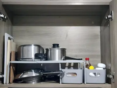 a kitchen with pots and pans on a shelf at Entire unit 1 Bedroom with City View - Paul Riley's Pad in Manila